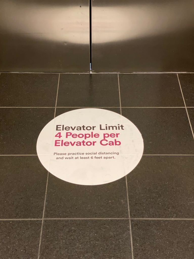 Signs indicate occupancy limits for elevators in The Galleria as part of the coronavirus precautions.  (Photo by Shelby Hodge)