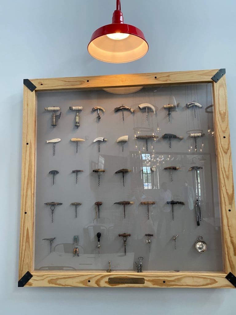 The Craig and Mary Jo Beyer cork collection adorns a wall in one of the two private dining rooms. (Photo by Shelby Hodge)