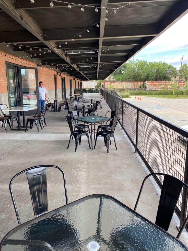 Bill Floyd overlooks the vast patio that backs up to the railroad track, an added dimension to the restaurant ambience. (Photo by Shelby Hodge)