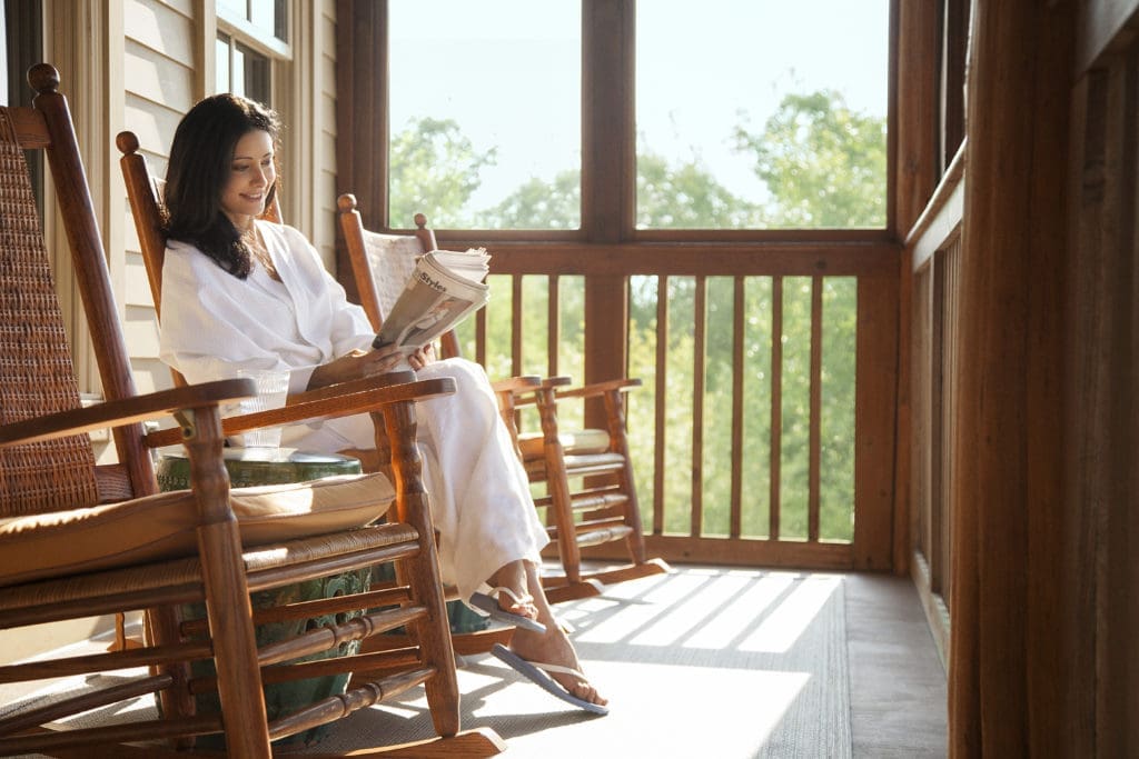 The JFK rockers on the Lake House porch provide serene moments overlooking the resort.  (Photo by Lake Austin Spa Resort)