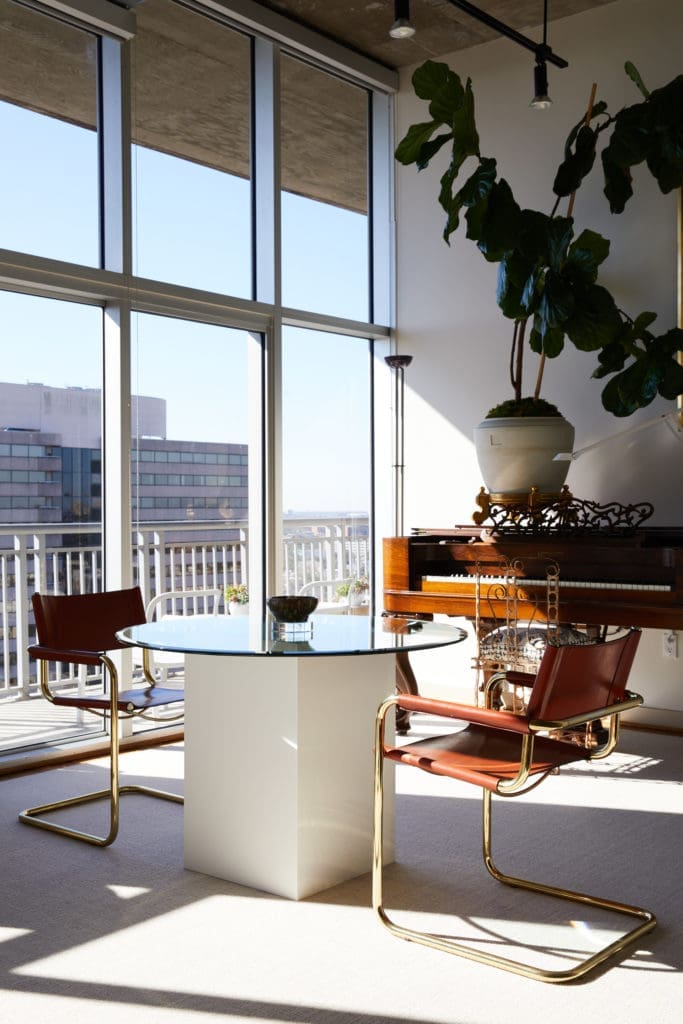 Christopher Alexander designed the laminate and glass table in the breakfast room. Vintage brass and leather Mart Stam chairs. (Photo by Pär Bengtsson)
