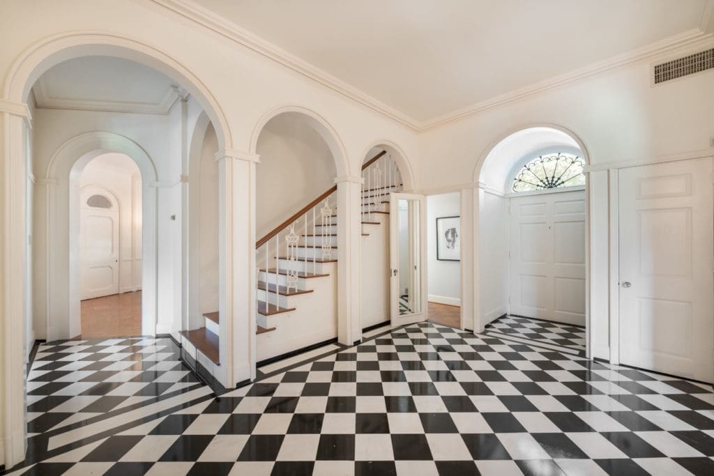 The black and white marble entry creates a powerful welcome to guests in the John Staub house. (Photo by Vlady Ambia)