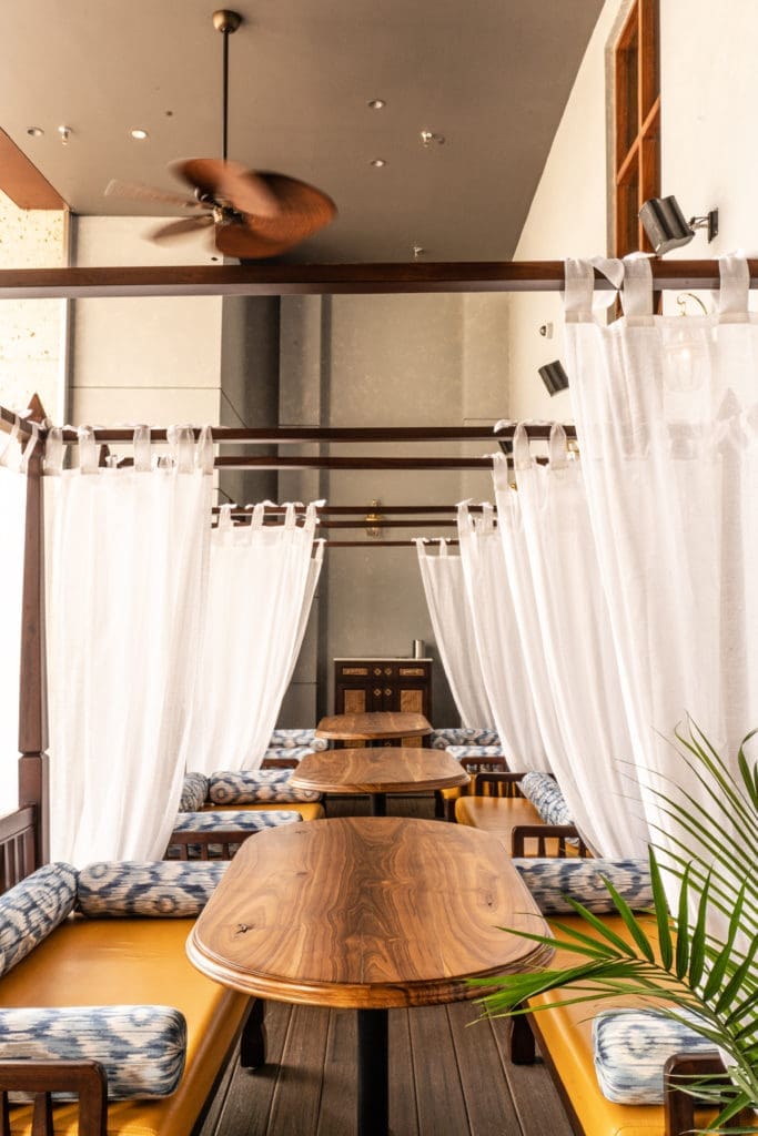 The outdoor lounge at Musaafer is complimented by daybeds draped colonial style in linen and featuring plump bolsters. (Photo by Michael Anthony)