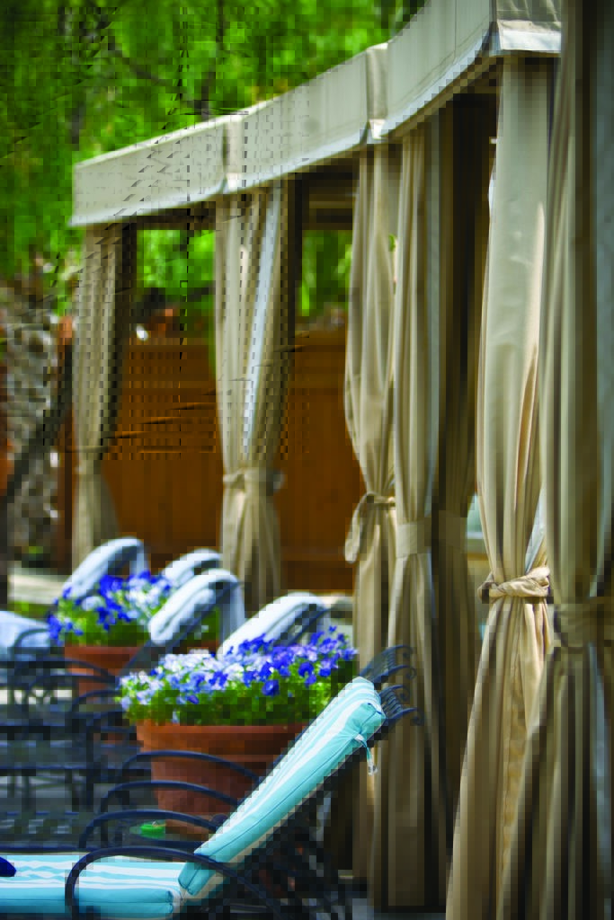 Cabanas by the Palm Pool offer inviting relaxation for both tanning and secluded relaxation. (Photo by Lake Austin Spa Resort)