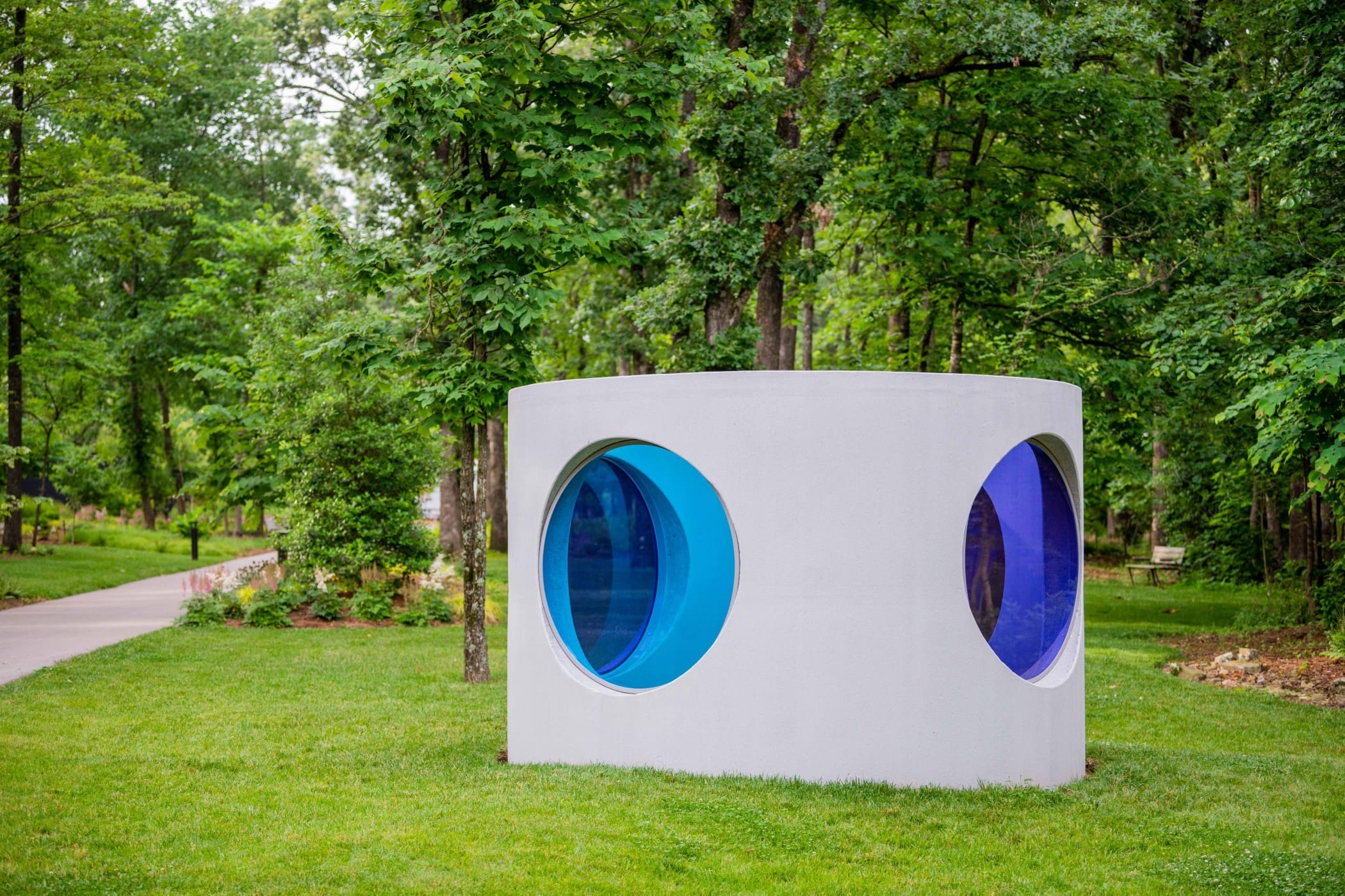 Sarah Braman's futuristic "Here," 2019, marries industrial material (a concrete drainage pipe) with powder-coated aluminum frames set with laminated glass of a buoyant blue hue. (Courtesy the artist and Crystal Bridges Museum of American Art, Bentonville, Arkansas)
