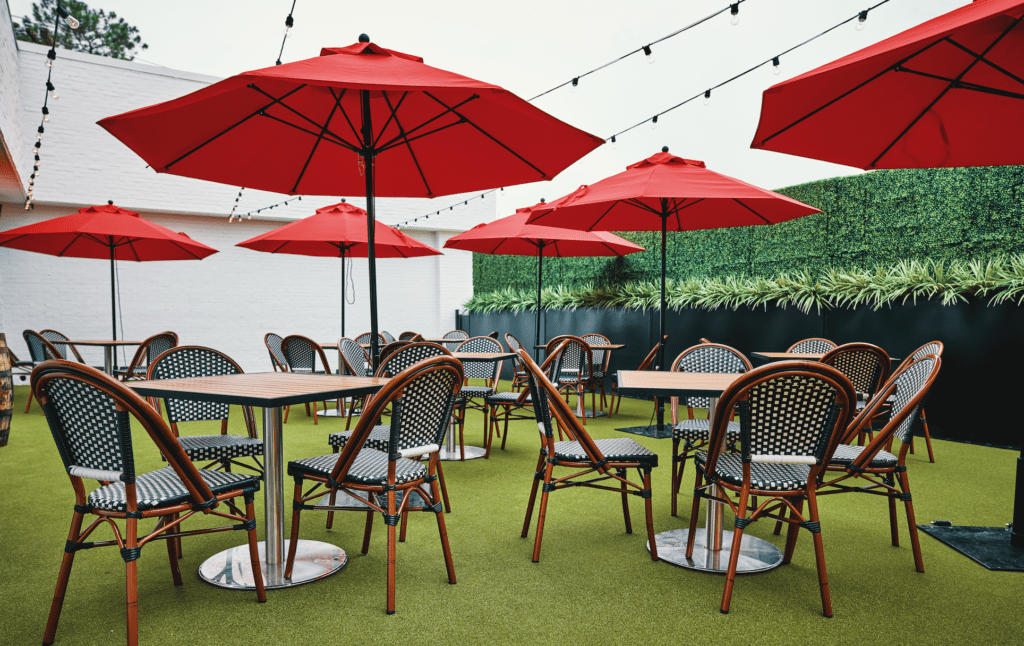 B.B. Italia adds colorful umbrellas, whimsical overhead lighting and artificial turf underfoot for a pleasant al fresco dining setting. (Photo by Fulton Davenport)
