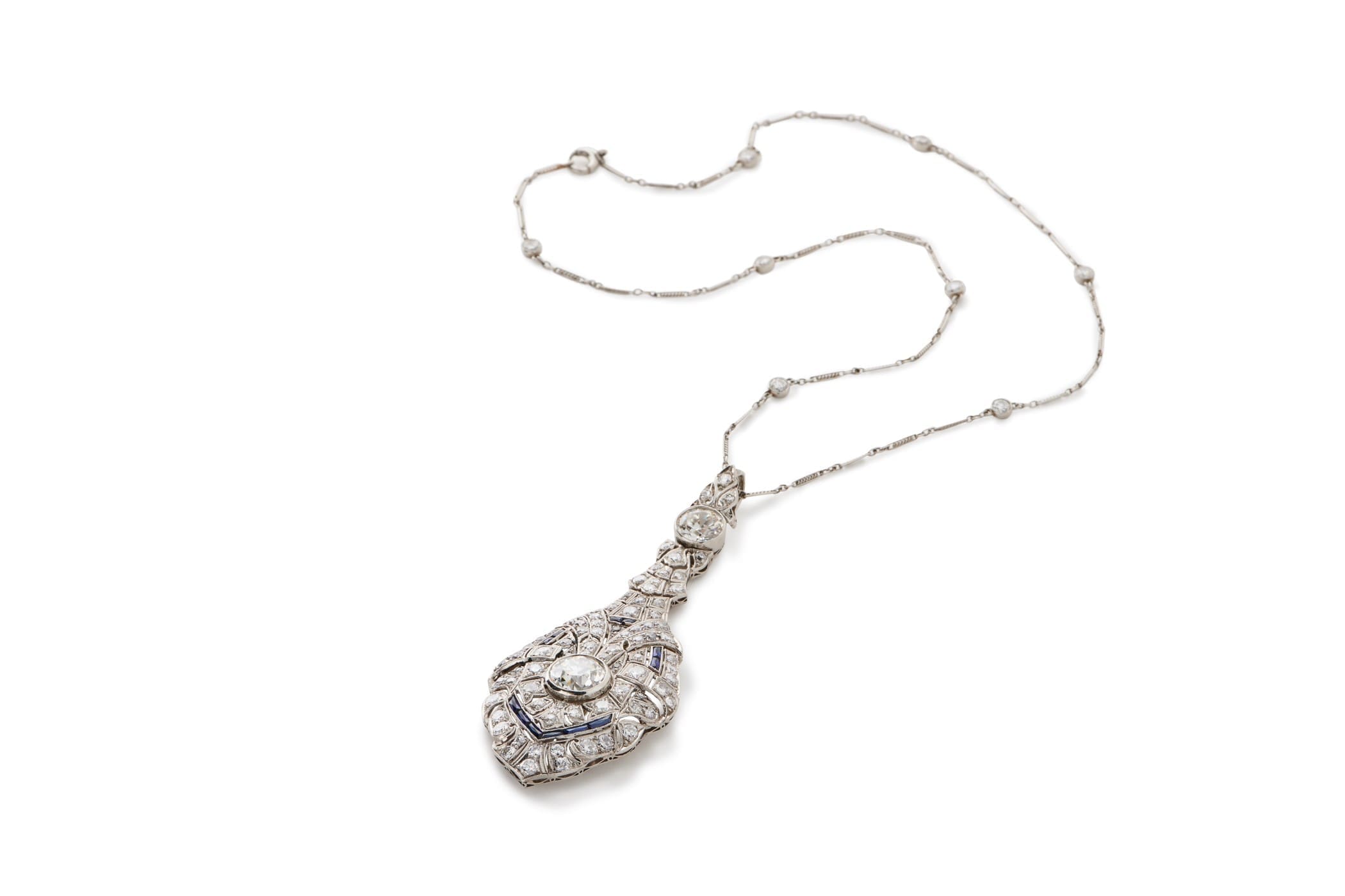An art deco diamond drop pendant adds and elegant touch.