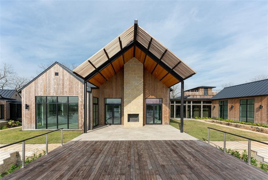 The back patio at 35711 Vernon Frost Road opens to a cantilevered deck the overlooks Lake Lucille. (Photo by ProHouse)