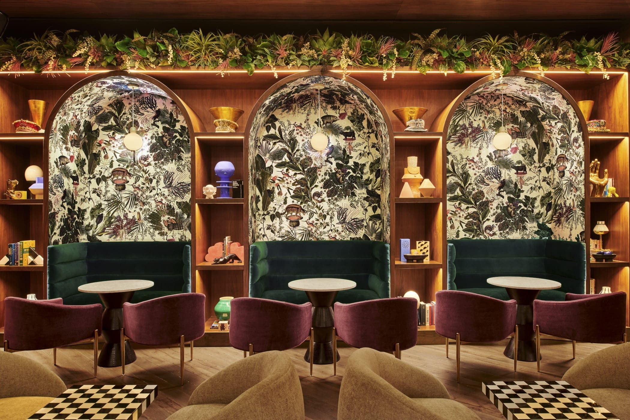 Joel Mozersky’s directive from Virgin for the <em>Funny Library Coffee Shop</em> was to be whimsical and surreal, and the Menagerie of Extinct Animals wallcovering from Moooi (available locally at ID Collection) fit the bill perfectly. Seating alcoves are built into the library shelving for an intimate feel. “The niches are always the first seats filled, because the people watching from them is great,” he says.