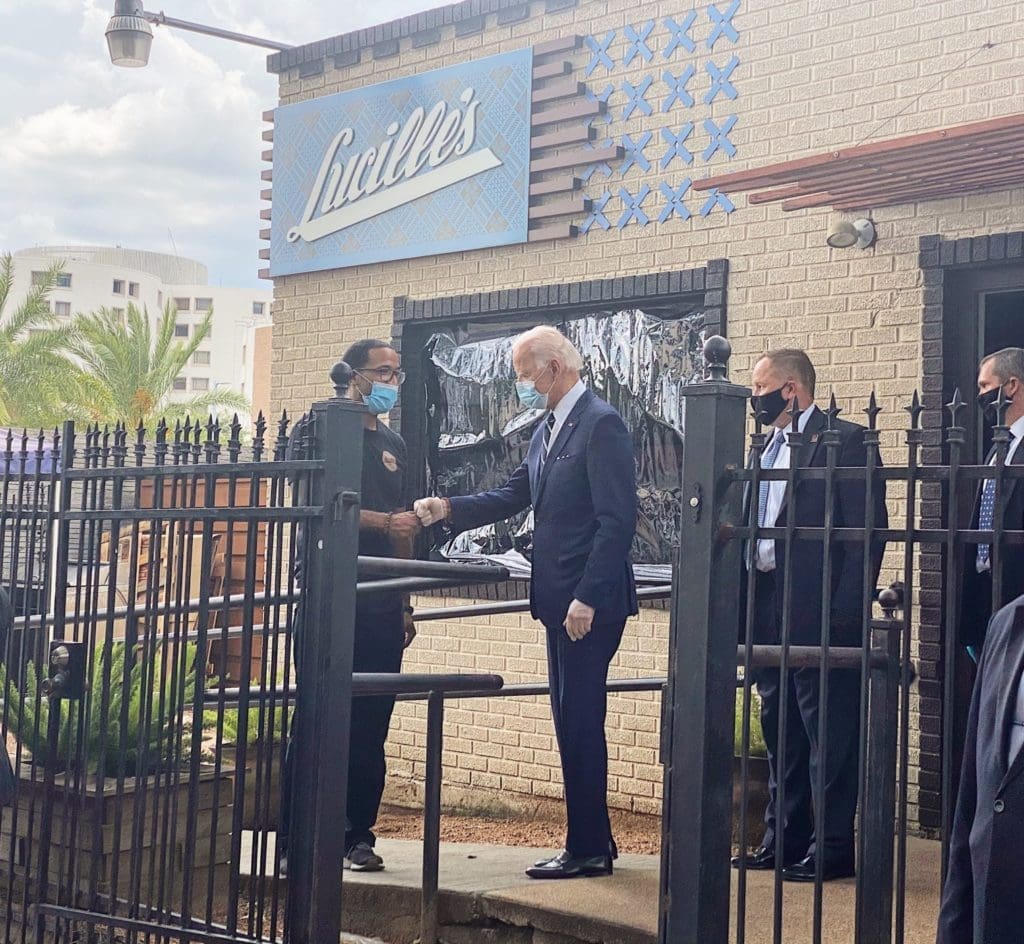Lucille's executive chef/ owner shares a hand bump with former Vice President Joe Biden at his Museum District restaurant where the Bidens met with the family of the late George Floyd.