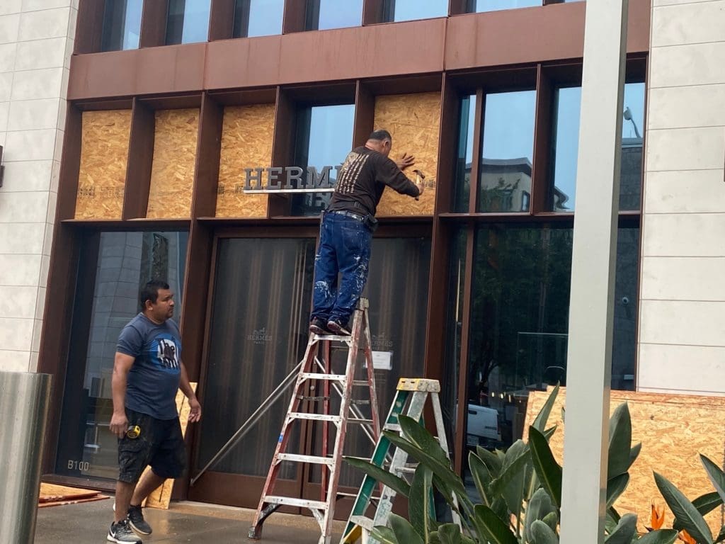 The Hermés crew at work boarding up windows and doors at the River Oaks District boutique. (Photo by Shelby Hodge)