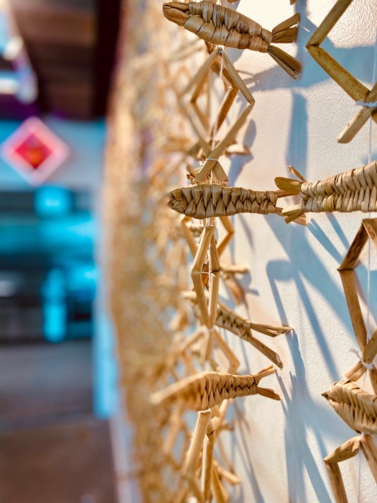 Woven fish line the walls and cast an artistic shadow at Museo II. (Rosalia Ramirez Antonio).