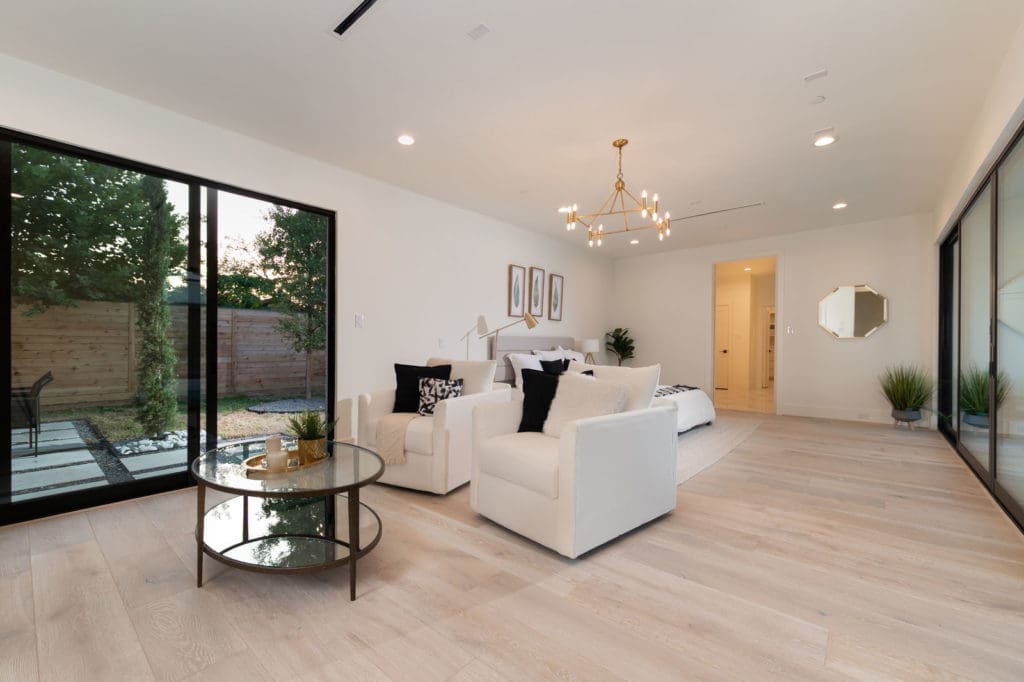 The primary bedroom with its sitting and private patio.