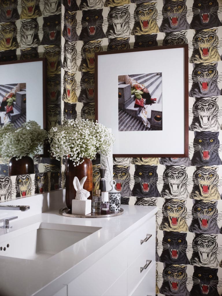 Gucci wallpaper adorns one wall in the bath room. The plaster rabbit sculpture is by George Sellers. (Photo by Lisa Petrole)