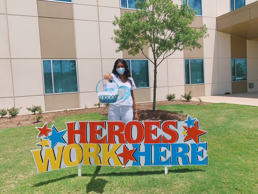 Gia McCrae visits Kelsey-Seybold Clinic to hand out a cookie basket to a healthcare worker.
