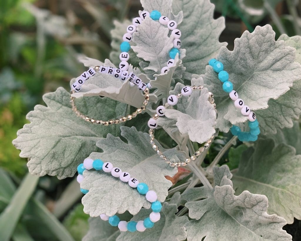 Gia McCrae makes L.O.V.E. Project bracelets for essential workers, friends, and family.