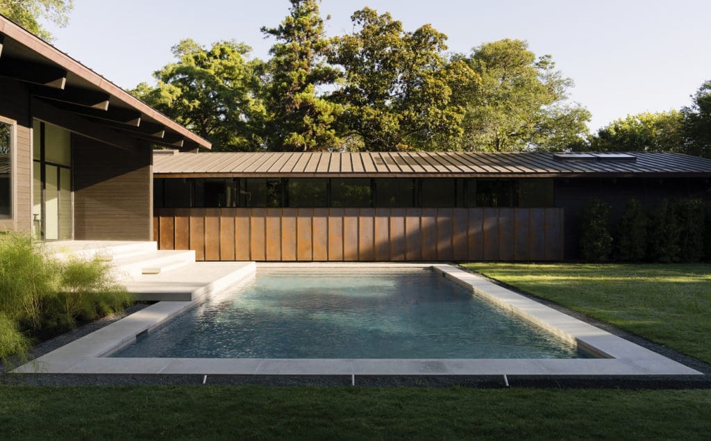 A swimming pool accents the formal interior yard. (Photo by Jack Thompson Photography)