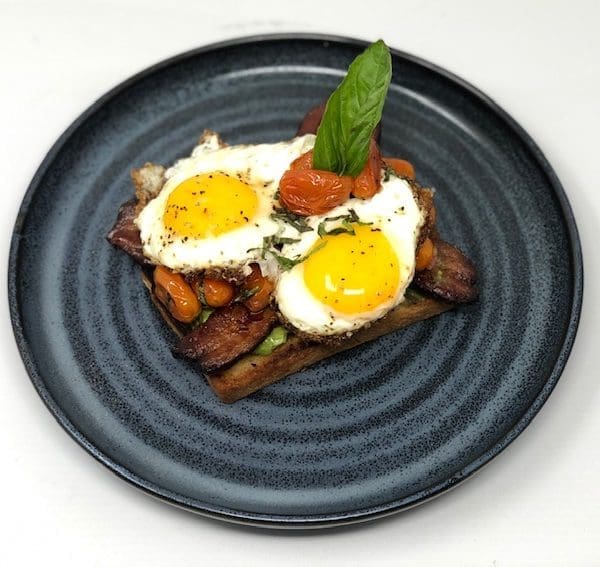 Avocado Texas Toast with Tomato-Basil Confit, Slab Bacon, Sunny Eggs