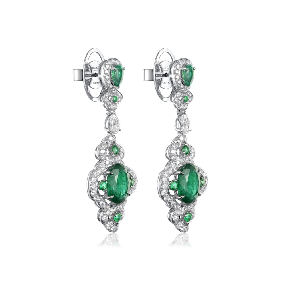 A close-up of Fabergé x James Ganh white gold, emerald and diamond earrings.