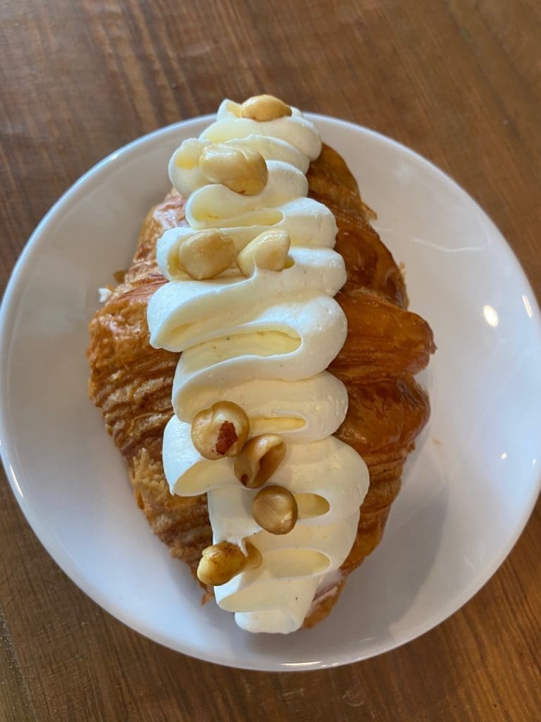 The amazing PJ&B croissant at While Elm Café composed of Peanut Butter, Strawberry Jam, Cream Cheese
Chantilly, and Roasted Salted Peanuts. (Photo by Shelby Hodge)