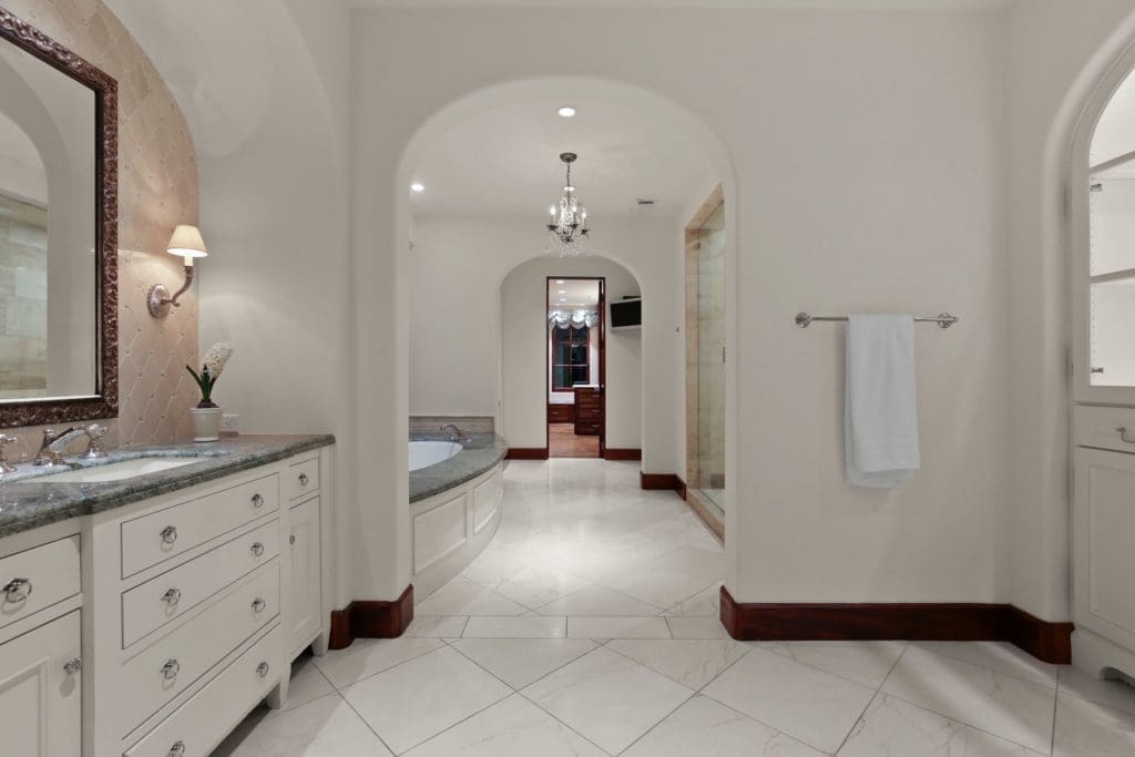 Space is separated with his and hers vanities and dressing.