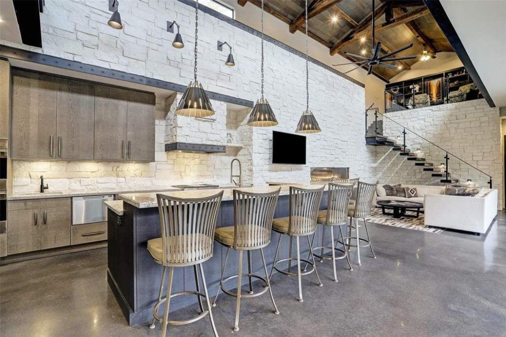 The kitchen has subtle design details such as custom iron banding above the cabinetry and at the vent hood.