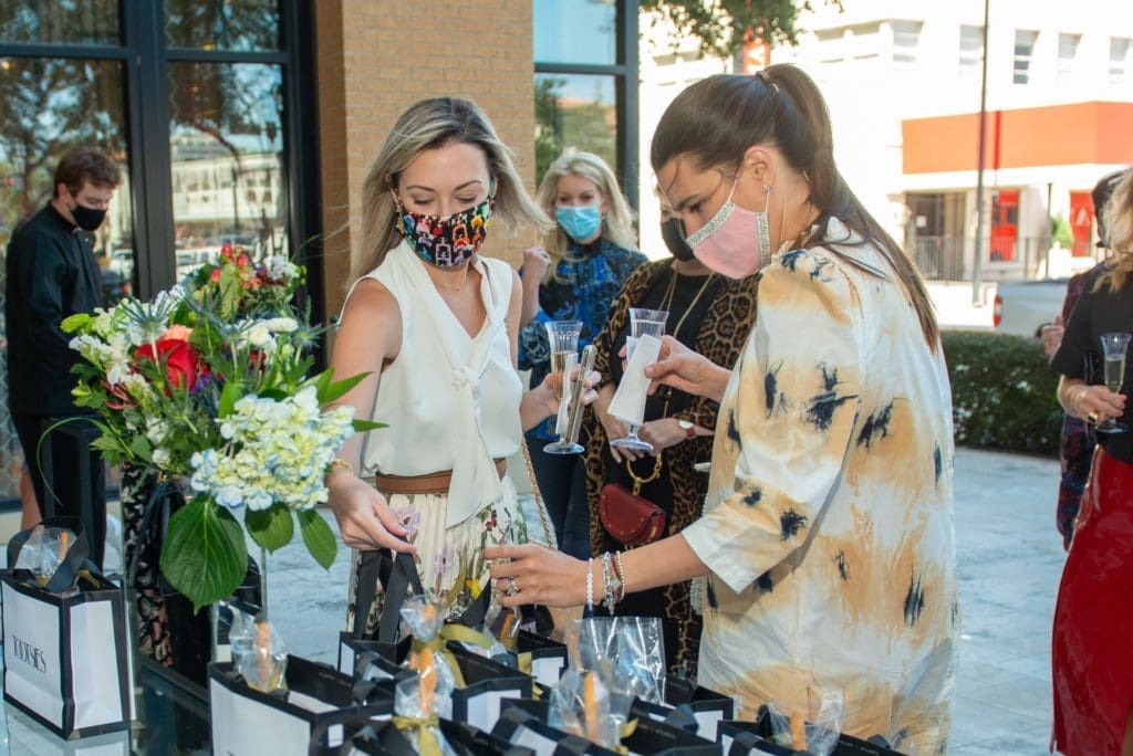 Katy Ellis and Kathryn Swain pick up their chacuterie lunch bags from Graze before the fashion presentation. (Photo by Jacob Power)