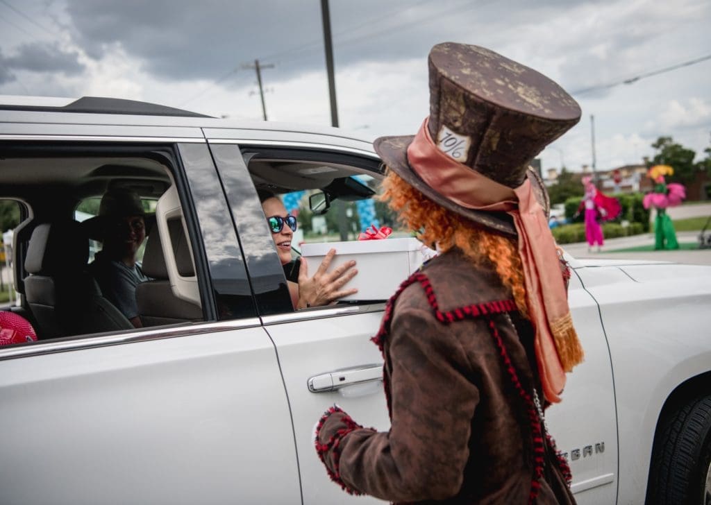 The Mad Hatter delivers craft kits to kiddos in the drive-through 'tea party.' (Photo by  Brandy Stoesz Photography)