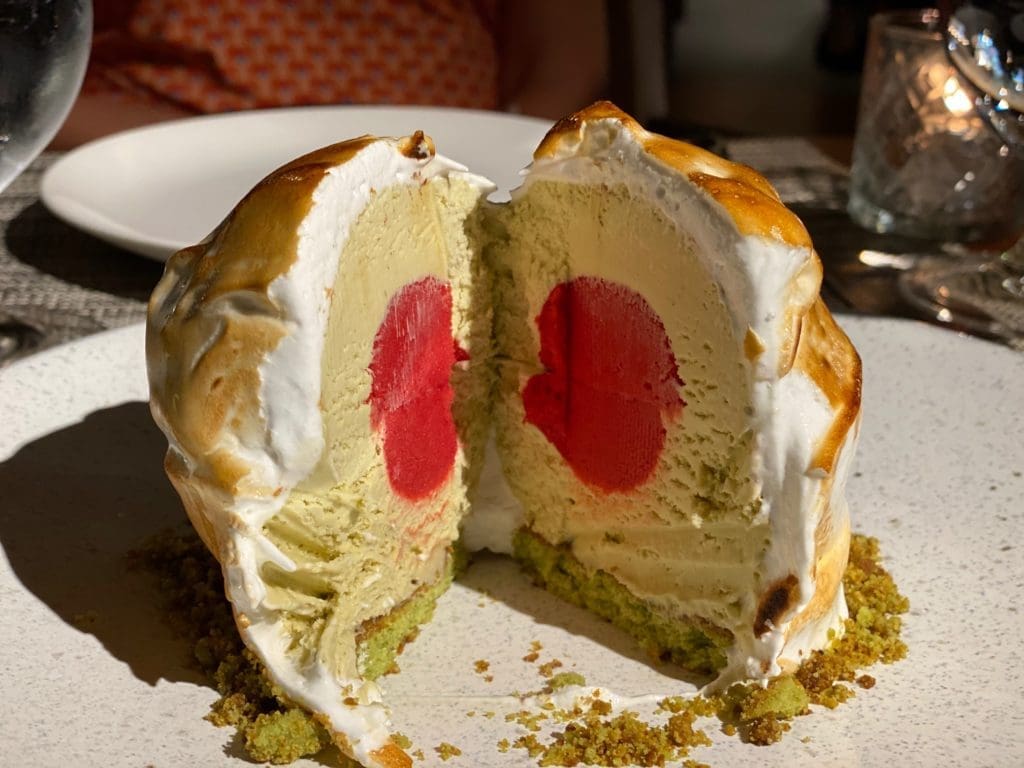 The Baked Alaska is filled with a layer of pistachio ice cream and centered with berry ice cream. (Photo by Shelby Hodge)