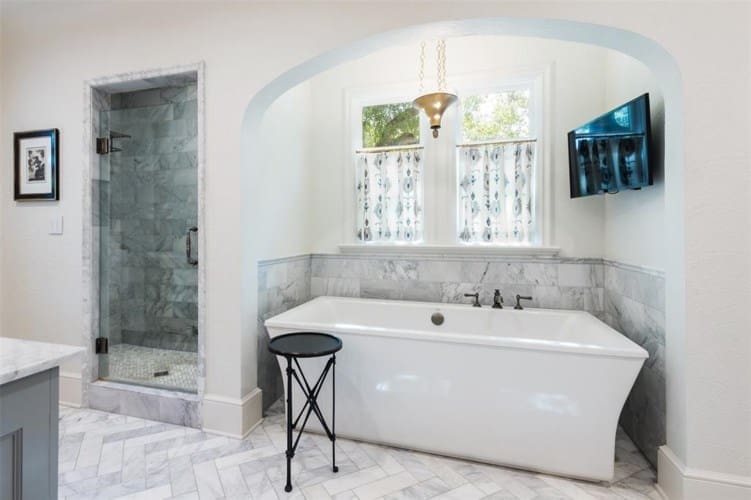 The master suite includes heated floors and a garden tub. 