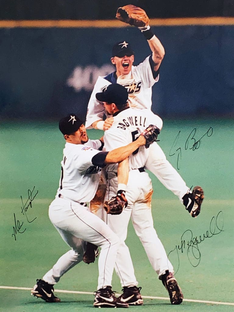 Jeff Bagwell lifts up Craig Biggio as Mike Hampton joins the vitory party at first base in the Astrodome’s final game on October 3, 1999. (Photo courtesy F. Carter Smith)