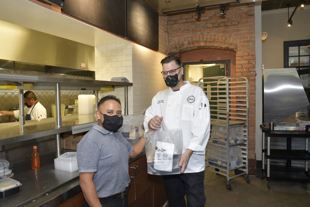 Potente Chef Danny Trace hands off a four-course dinner package from the kitchen at Minute Maid Park. (Photo by Jerry Klumpp)
