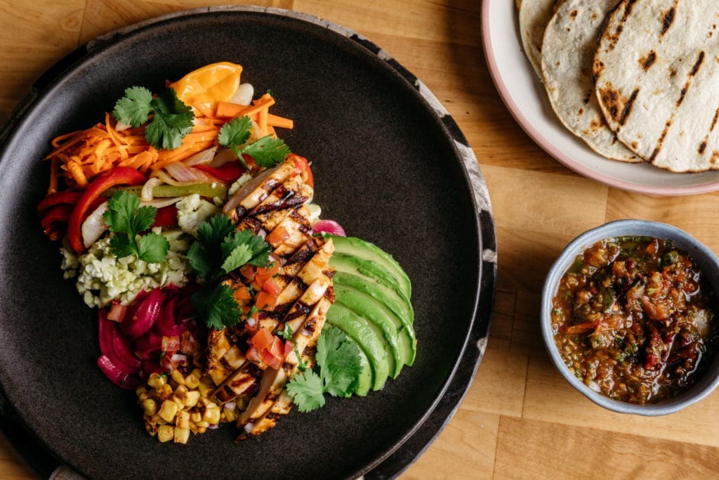 The skinny fajitas at Tejas come with your choice of protein, corn tortillas, and cauliflower rice.