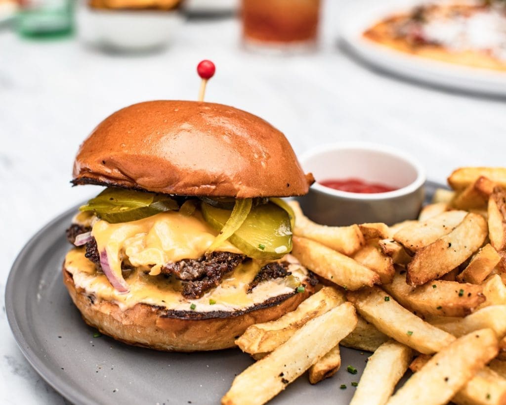 The Sporting Club Burger and hand-cut fries cooked in beef fat is a menu favorite of The Sporting Club director of operations for Houston Brandon Duliakas. (Photo by Corine Michel )