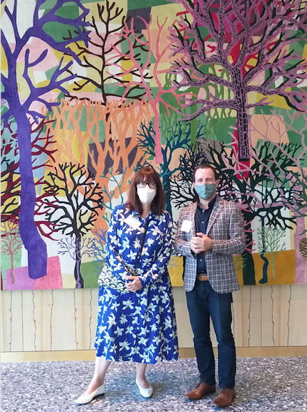 MFAH curator Alison de Lima Greene and Jaime Odabachian of the artist-tapestry firm Odabashian pose in the MFAH future formal restaurant space, Le Jardinier, with Trenton Doyle Hancock's commission, "Color Flash for Chat and Chew, Paris Texas in Seventy-Two," 2019-2020. (Photo by CDA)