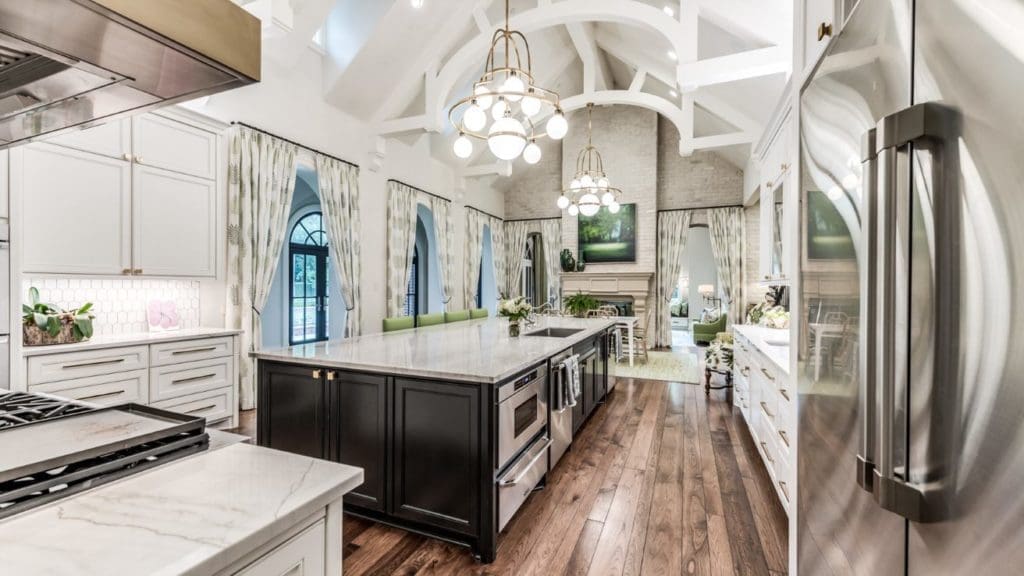 The kitchen and family room share vaulted ceilings and a limed brick double sided fireplace.