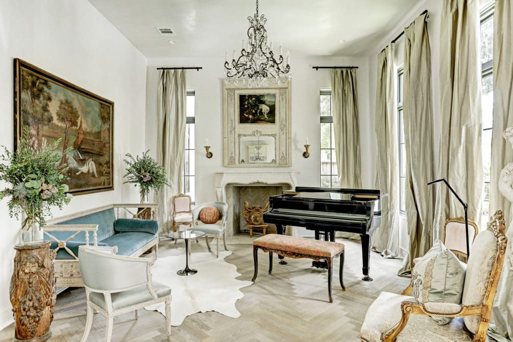 The formal living room at 722 E. Friar Tuck Lane is centered around the gas fireplace with a late 18th century mantle from Bordeaux.