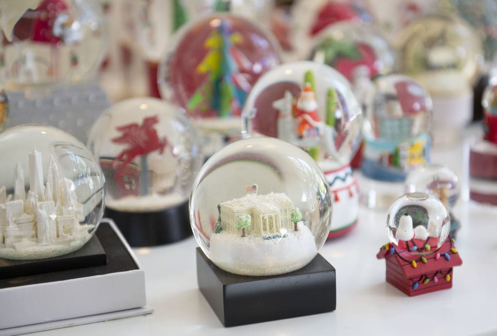 Smiley's snow globe collection fills the table.