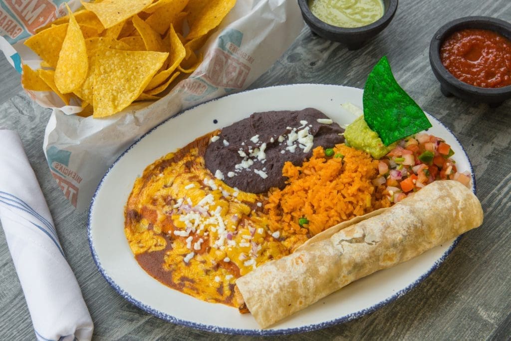 Fronnie's Superior features a large chicken fajita taco and a cheese enchilada served with your choice of guacamole, pico de gallo, Mexican rice, and your choice of beans. 
