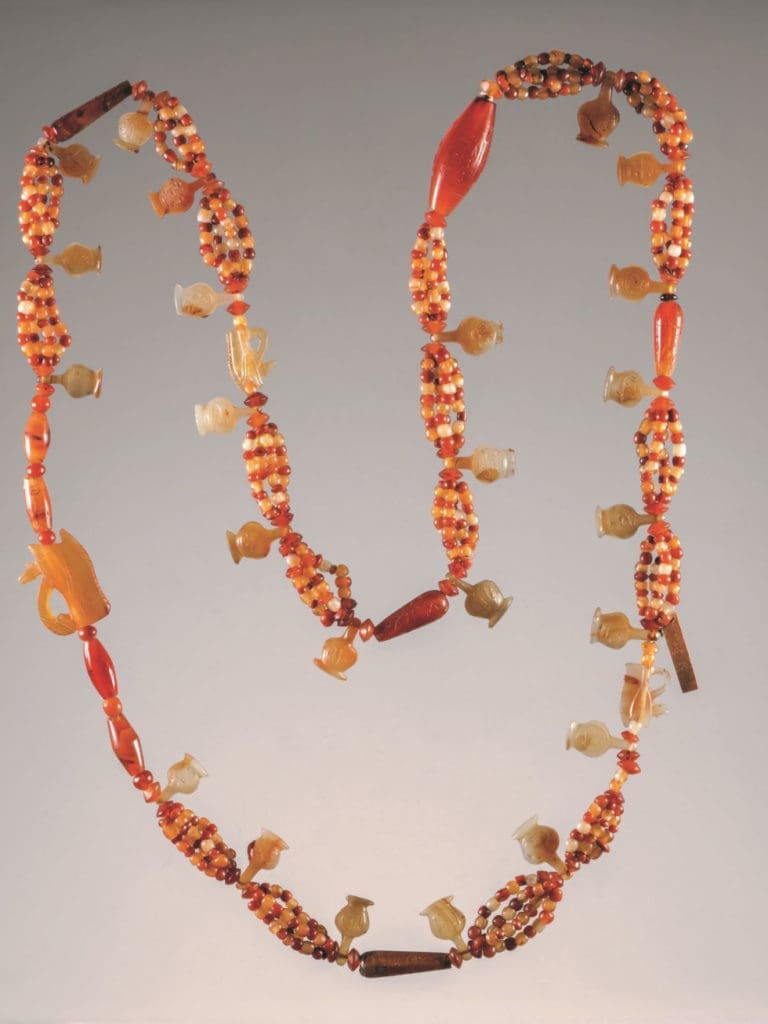 Bead and amulet necklace made of quartz, lapis lazuli, carnelian, and amphibolite.