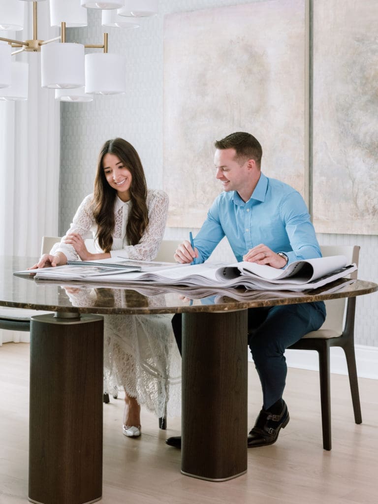 CASA Houston's Mackenzie Cash and Mirador Group principal Jerry Hooker study design options for the residence in The Sophie at Bayou Bend. (Photo by Divya Pande)