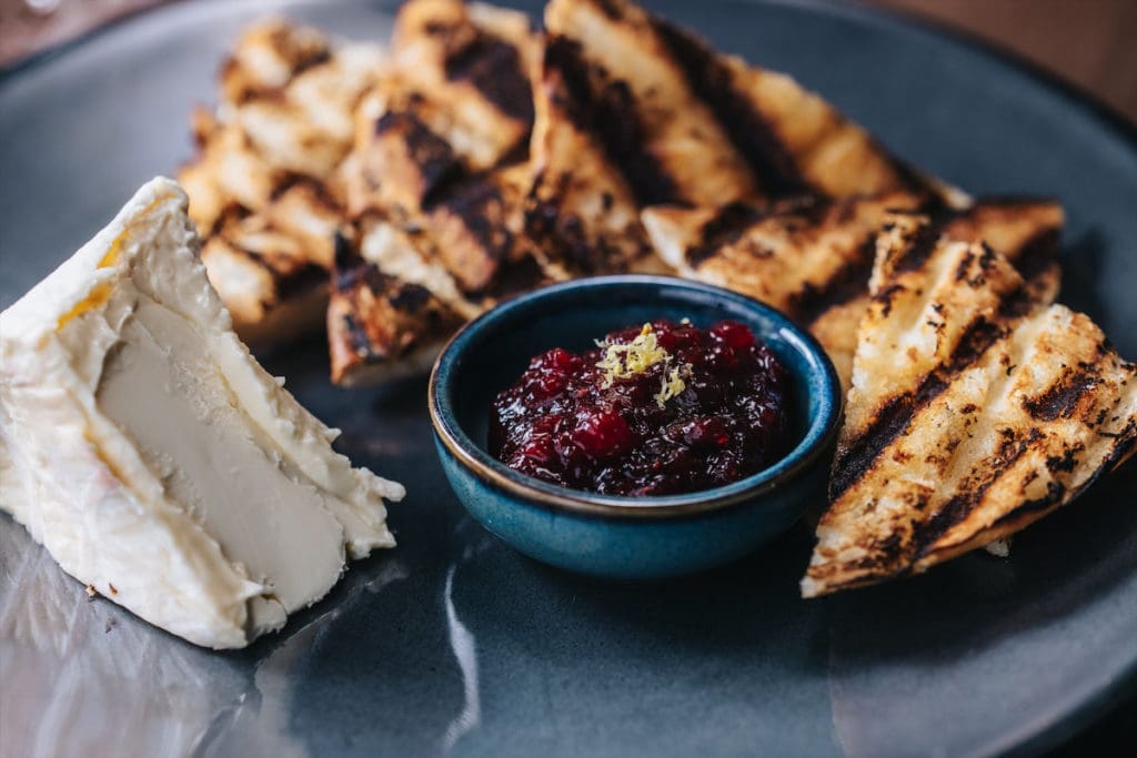 A triple cream cheese with jam and toast also serves as a snack at Ounce. (Photo by Kathy Tran)