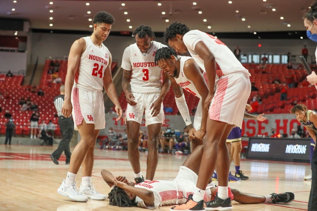 UH's basketball players are sometimes floored, but they always help each other back up. This is a team that stays together. (Photo by UH Athletics)