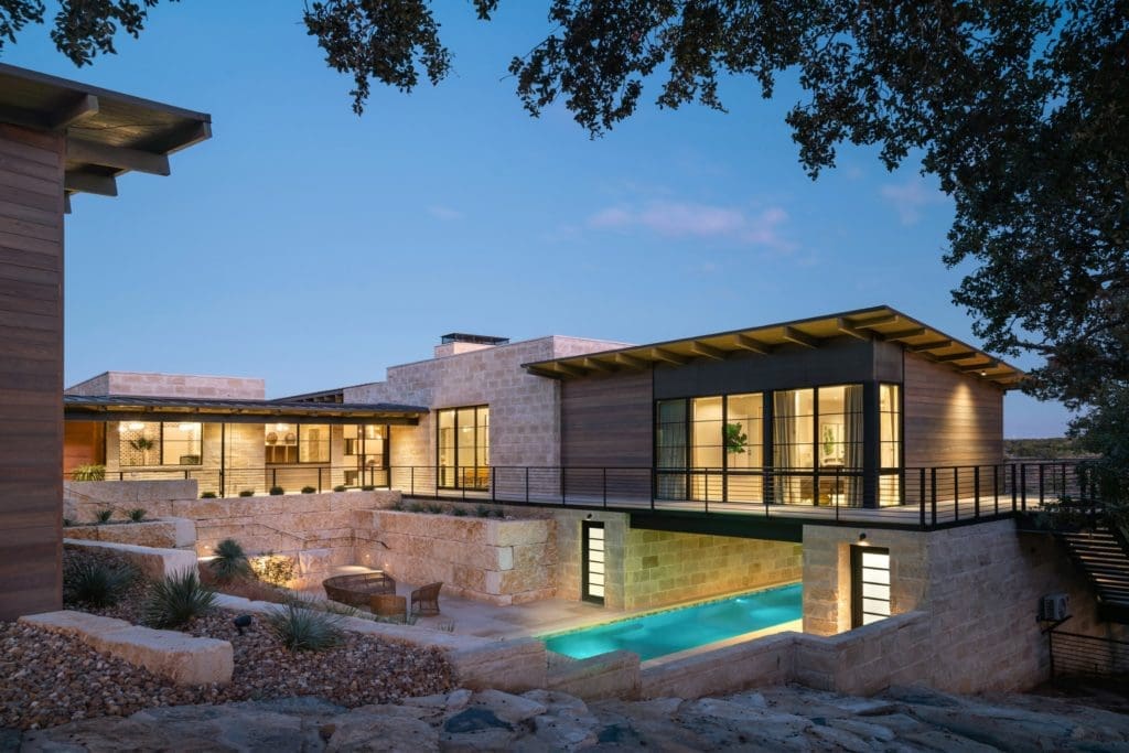This modern ranch in the Hill Country, by J Christopher Architecture, rests atop a rocky cliff overlooking rushing creek waters. (Photo by Chase Daniel)