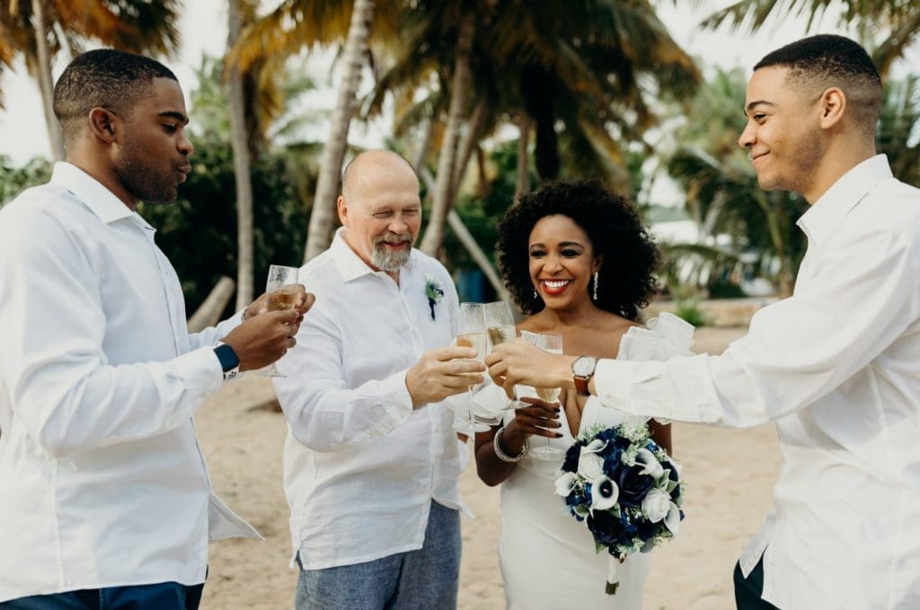 Raphael Chaumette, left, joins his brother Alexandre Chaumette in toasting the newlyweds James Craig and their mother, Jacquie Baly, during the couple's wedding in St. Croix in the U.S. Virgin Islands. (Photo by Meredith Zimmerman)