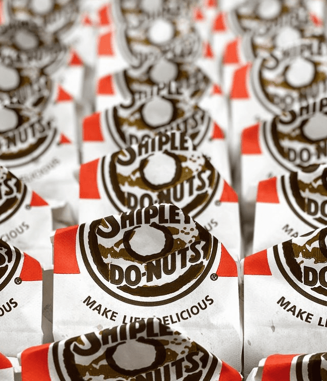 Rows of fresh donuts, kolaches, and donut holes in Shipley Do-Nuts bags display the power of Texans' favorite donuts. (Photo courtesy Shipley Do-Nuts).