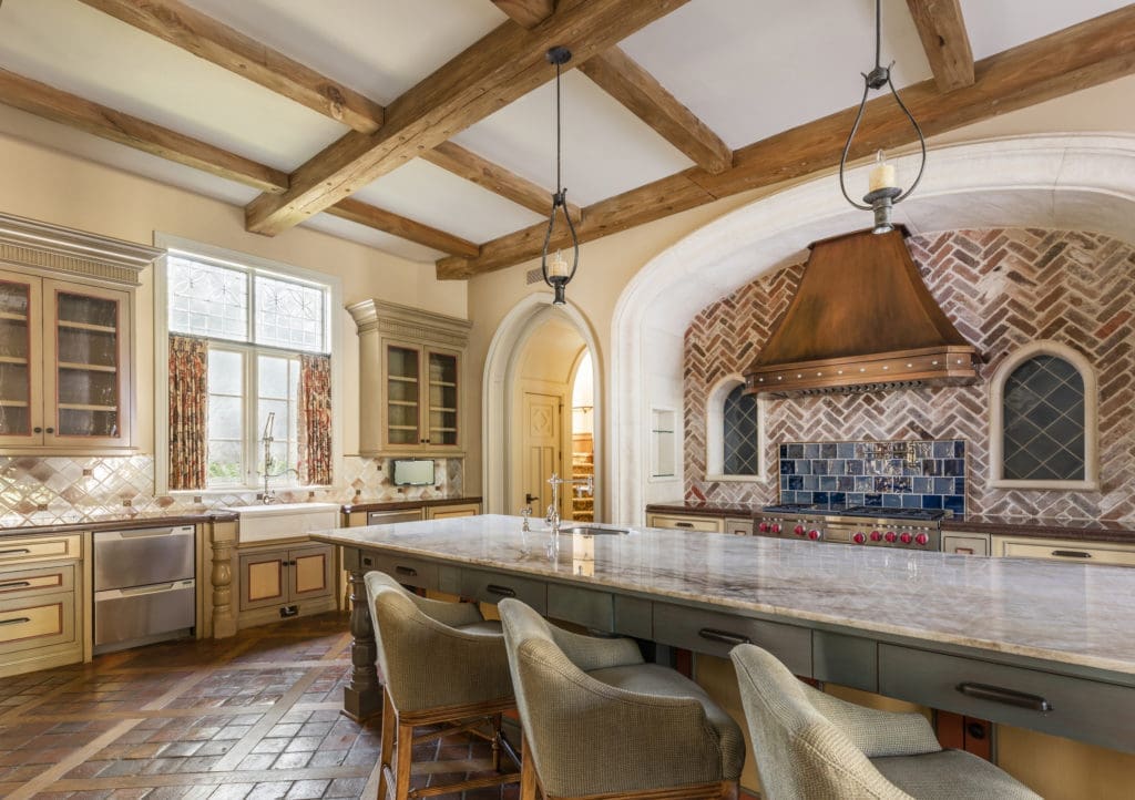 The 12 ft. coffered ceilings of the kitchen at 3996 Inverness are accented by repurposed timber beams from trees fallen on the grounds after Hurricane Ike (Photo by Julie Soefer)
