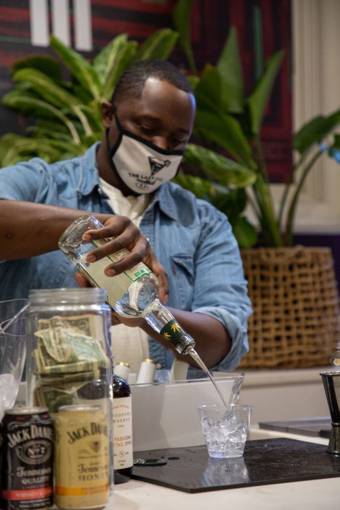 Bartender, Clif Taylor, was a popular man all night at the opening of "Collect It For the Culture III." (Photo by Nicole Electra)