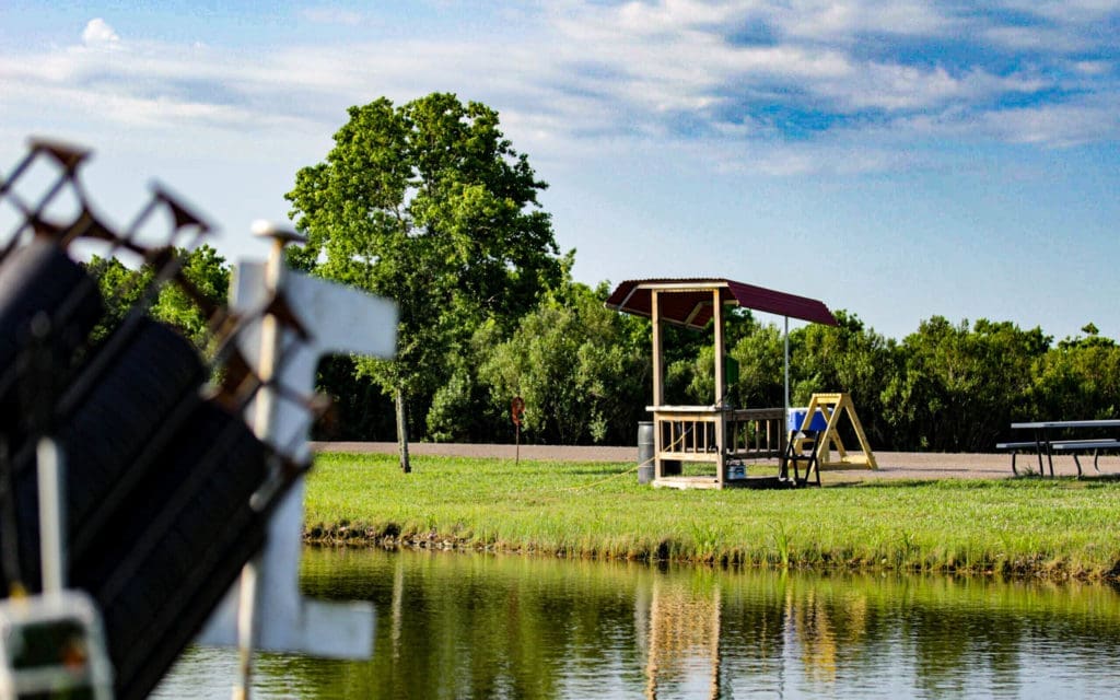 A skeet station stands at the edge of one of Greater Houston Sports Club's ponds.