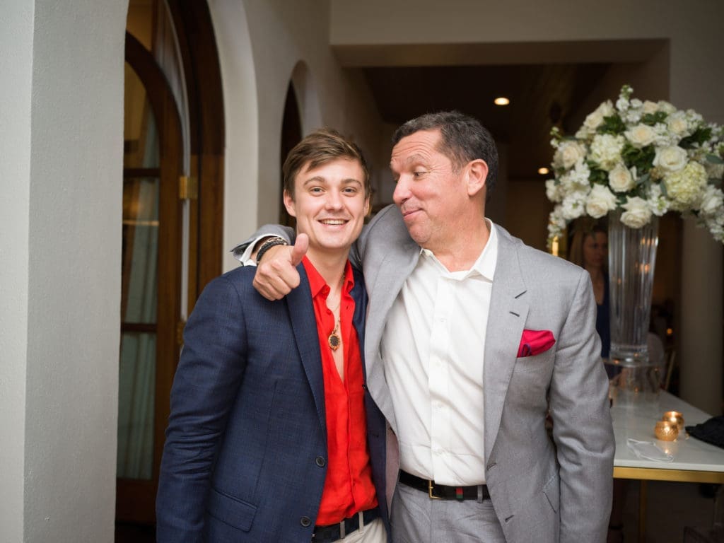 Robert Moody III, brother of the bride, shares a moment with Tony Buzbee at the engagement party.